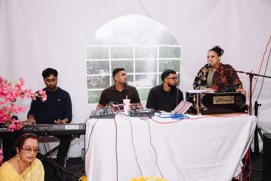 Keyboard, harmonium and sound mixer on a white table at a home event